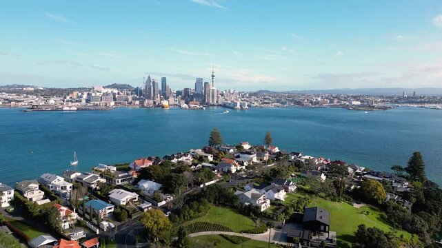 Auckland, New Zealand: Aerial drone footage of the luxury residential district of Stanley Point with Auckland downtown district skyline in the background. 