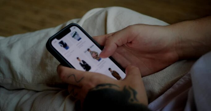 Man uses an e-commerce website to buy outerwear. Modern devices and online shopping concept