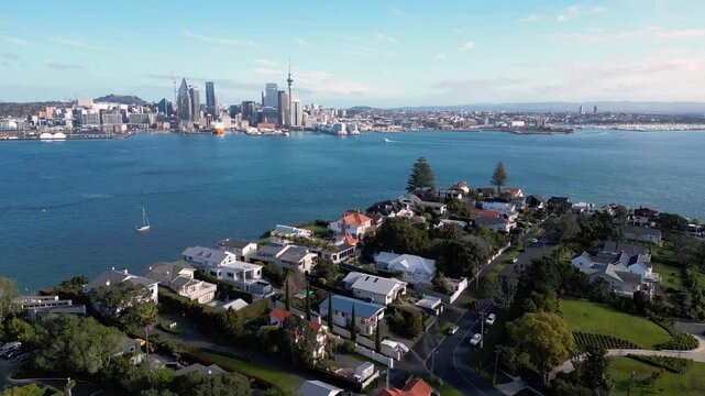 Auckland, New Zealand: Aerial drone footage of the luxury residential district of Stanley Point with Auckland downtown district skyline in the background. 