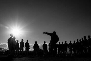 円陣を組んで指示を出す野球部の監督