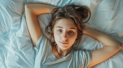 Fototapeta premium Top view of skinny girl wearing comfortable clothes in bedroom