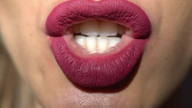 Macro lips. Professional makeup. Closeup of woman mouth with lipstick on lips. Beauty and makeup. Close up cosmetics for lips. Make up, applying lipstick, lips gloss on mouth. Beauty lip.