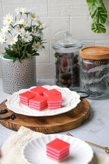 Kuih Lapis, a traditional Malay layered steamed cake and dessert, in white plates.