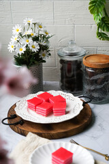 Kuih Lapis, a traditional Malay layered steamed cake and dessert, in white plates.