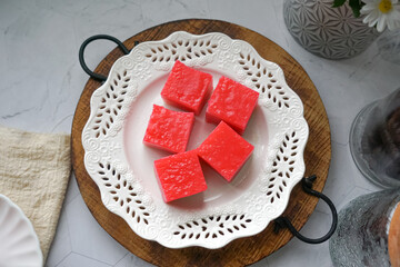 Kuih Lapis, a traditional Malay layered steamed cake and dessert, in white plates.