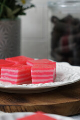 Kuih Lapis, a traditional Malay layered steamed cake and dessert, in white plates.