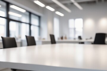 A silver blurred office interior featuring a desk with a laptop and computer, complete with a chair, monitor, keyboard, and other workspace essentials