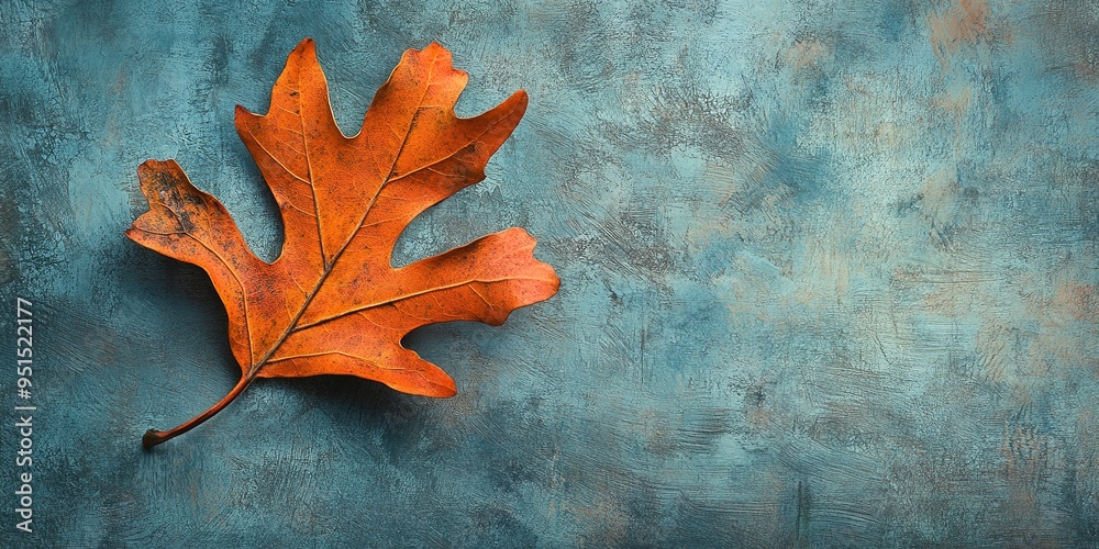 Poster Single orange oak leaf on a textured background. 