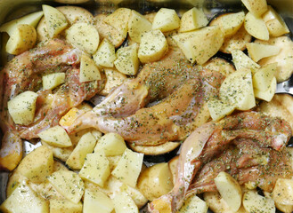 Prepared in the oven, chicken, with eggplant and potatoes, with a touch of spices, oregano and pepper. Close up and zenith view.