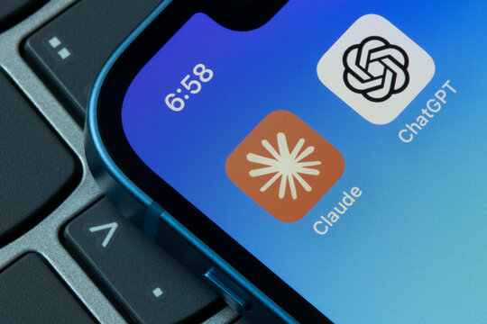 Portland, OR, USA - Aug 30, 2024: Claude and ChatGPT app icons are seen on an iPhone. Generative AI competition, Anthropic vs OpenAI, and Claude vs ChatGPT concepts.
