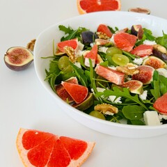 Healthy Salad with Arugula, Grapefruit and Figs Close up Photo