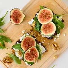 Toast with Figs, Cheese and Arugula on Bread Slice Photo