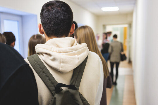 Group of students and school pupils in a science museum exhibition, excursion tour with guide, a docent with a tourist visitors, school field trip, attendees of technical museum exposition gallery