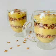 Healthy Mango Smoothie with Granola in Glass Closeup Photo