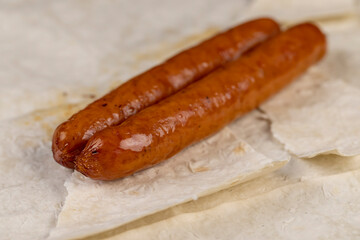 cooked pork sausages on fresh pita bread made from wheat flour