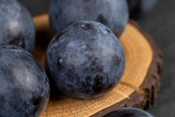 ripe purple plum on the table