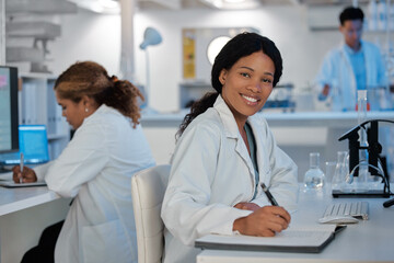 Fototapeta premium Portrait, smile and woman in laboratory for science, healthcare and writing findings at table. Scientists, happy and tech in research facility for microbiology, vaccine development and chemistry