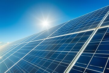 A close-up view of solar panels reflecting sunlight under a clear blue sky, symbolizing renewable energy and sustainability.