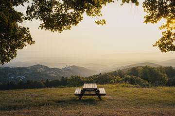 bench on top of a hill with a view over a valley