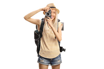 Female tourist with a backpack taking a photograph