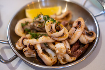 Grilled squid with vegetable and lemon served on plate