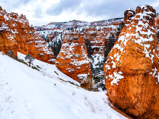 Snow scene colorful cliffs with red rock and stone in Bryce Canyon National Park