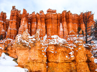 Snow scene colorful cliffs with red rock and stone in Bryce Canyon National Park
