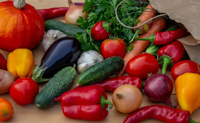 fresh vegetables and paper bag on wooden background. Selective focus