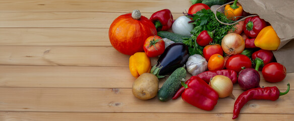 fresh vegetables and paper bag on wooden background. Selective focus
