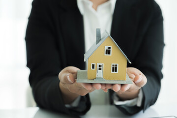 Real estate agent handing property keys to customer.