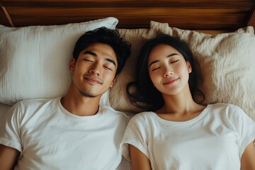 A relaxed couple, both with closed eyes and gentle smiles, lie next to each other on a comfortable bed, appearing peaceful and content in a warm, intimate bedroom setting.