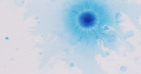 blue ink drops spreads on white wet paper