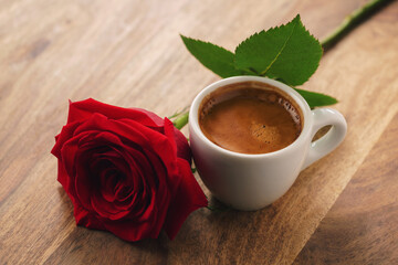 fresh espresso with red rose flower on wood table