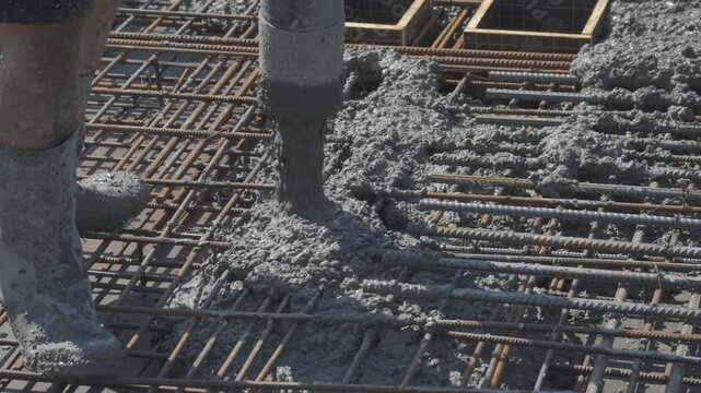 Builders at the construction site pour the surface with a mixture of cement and small gravel to concrete the construction site of a residential building
