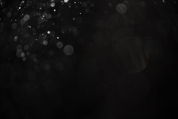 abstract real dust floating over black background for overlay