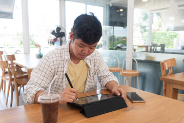 Lifestyle man using smart phone and tablet computer to work with financial data in the work space. Business Concept