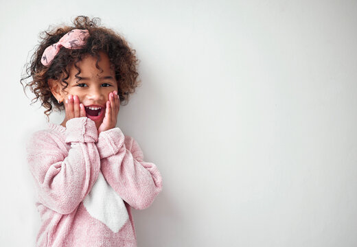 Surprise, happy and portrait of child in studio with mockup space for deal, promotion or prize. Shock, winning and girl kid from Colombia with wow, excited or omg expression by white background.