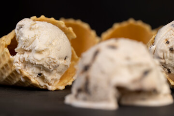 creamy ice cream with pieces of chocolate on a black slate