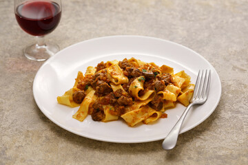 Homemade pappardelle pasta with lamb ragu sauce. Italian cuisine.