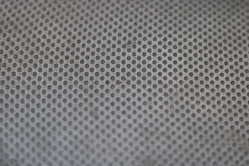 Close-up of gray surface with circular pattern.