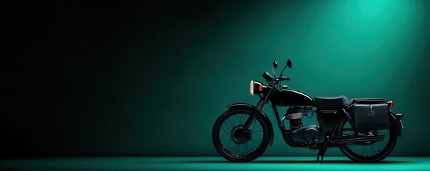 Fototapeta premium Stylish motorcycle in dramatic lighting against a dark background, showcasing its sleek design and vintage charm.