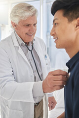 Fototapeta premium Doctor, patient and stethoscope in clinic for medical examination, checkup and consultation. Mature, physician and male person with health, heart beat and breathing for care or medicine in hospital