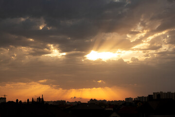 Sunset over multi-story buildings. Cityline with colorful sky. Residential area of the city in evening. Cityscape with summer sunset. Town, metropolis. Sunset over city. Evening city landscape