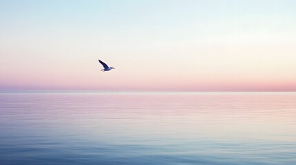 A single bird flying over a calm sea at dusk with a blue and pink sky, creating a peaceful and minimal scene.