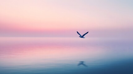 A single bird flying over a calm sea at dusk with a blue and pink sky, creating a peaceful and minimal scene.