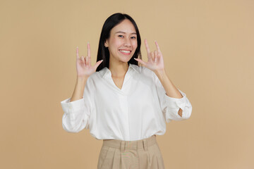 Smiling Woman Making I Love You Gesture in Sign Language, Beige Background