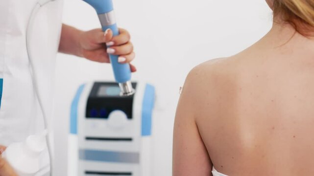 Effective Shockwave Therapy for full-body wellness. A young woman receiving treatment for pain relief and muscle recovery. Enhances overall health and promotes healing.
