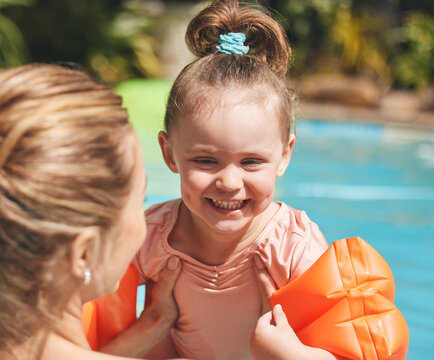 Learning, happy and child with swimming instructor in pool for lesson, education or practice in summer. Sweet, outdoor and teacher with girl kid in water for aquatic exercise, growth or development.