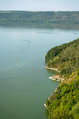 Unique nature of Dniester River and Bakota Bay. 
Late summer or early autumn boat tour travel along the high banks on the slopes of beautiful Khmelnytskyi region in Ukraine.