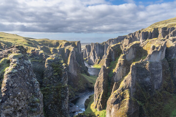 The view of  Fjaðrárgljúfur Canyon under cloudy sky. Photo from southeast Iceland.
